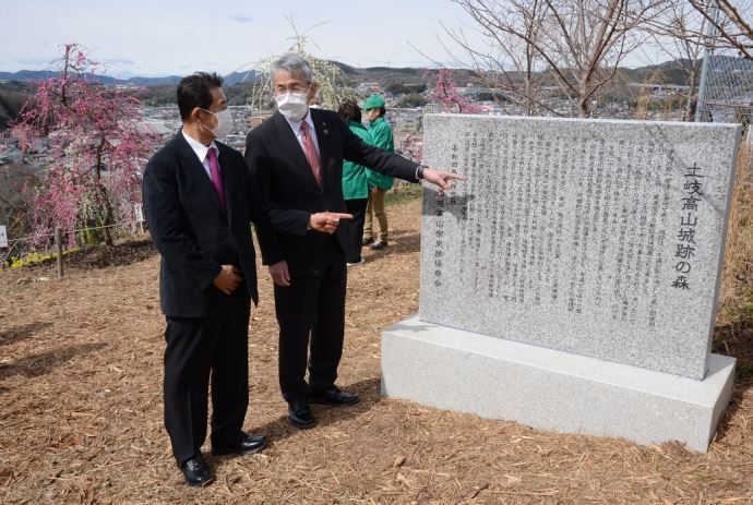 写真：高山城高山宿史跡保存会10周年記念で設置した石碑を見る土岐市長